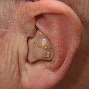 A hearing aid in someone’s ear